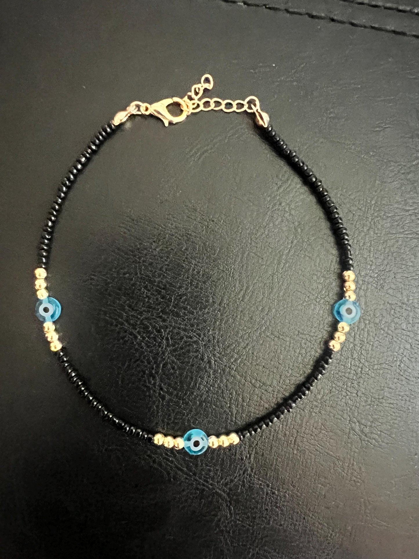 Black bead, Anklet, evil eye, summer beach. Add a touch of glamour with this lightweight ankle bracelet with an evil eye charm