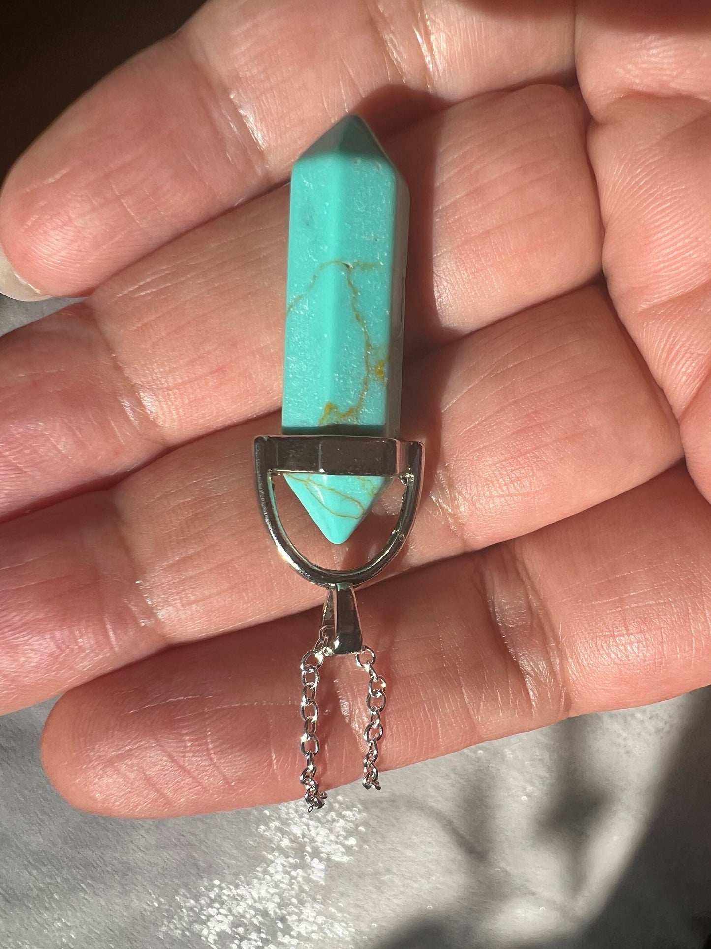 Protective Rose Quartz pendant with gold chain.