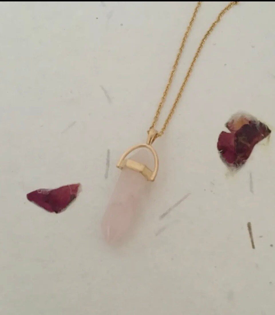 Protective Rose Quartz pendant with gold chain.
