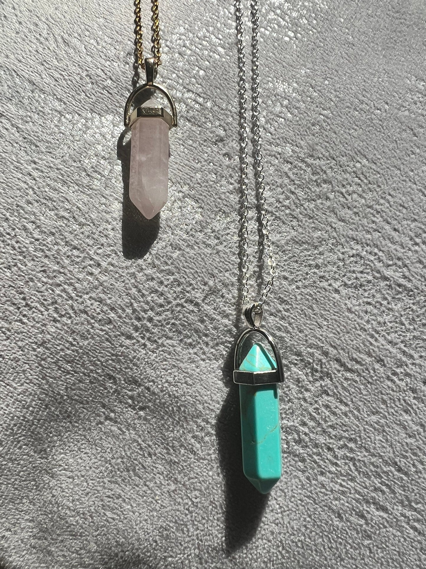 Protective Rose Quartz pendant with gold chain.