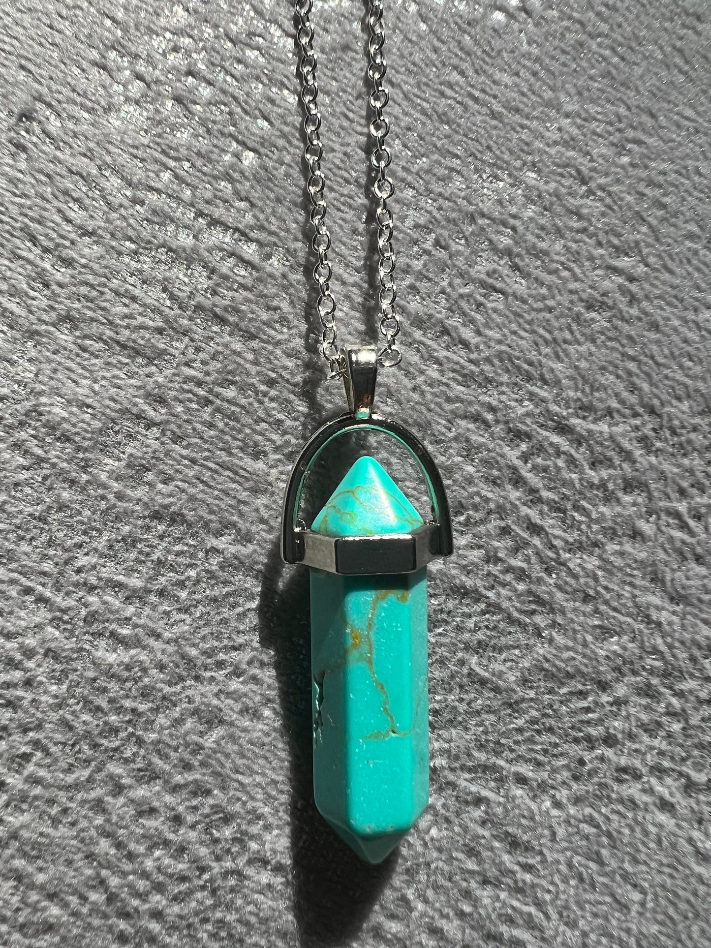 Protective Rose Quartz pendant with gold chain.