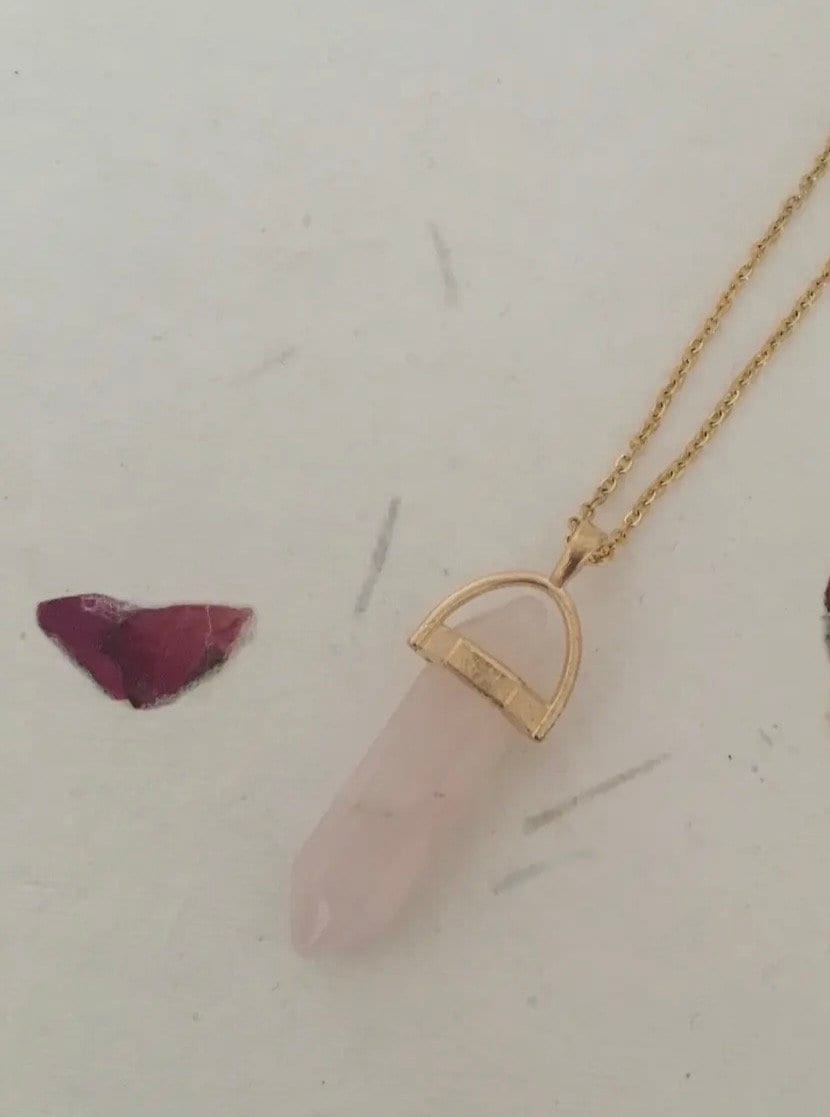 Protective Rose Quartz pendant with gold chain.